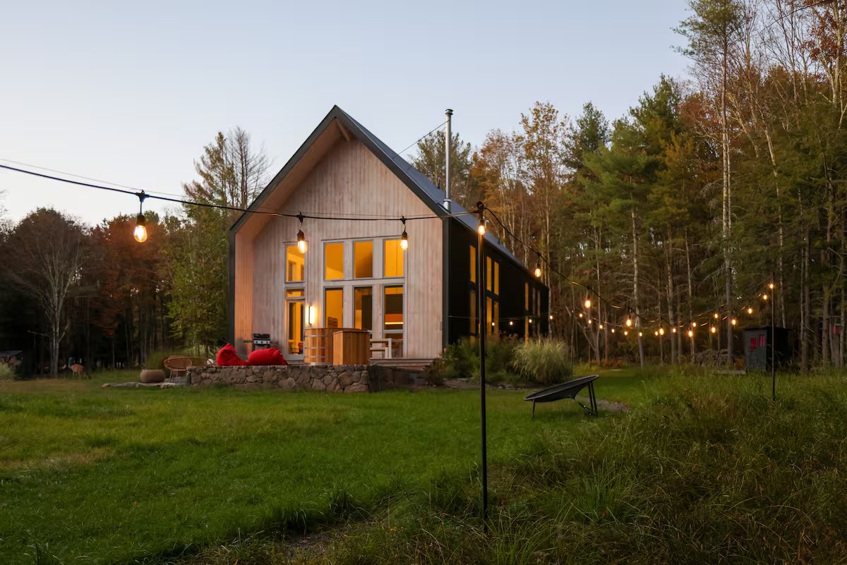 Vinyl Pines — the cabin at dusk with string lights